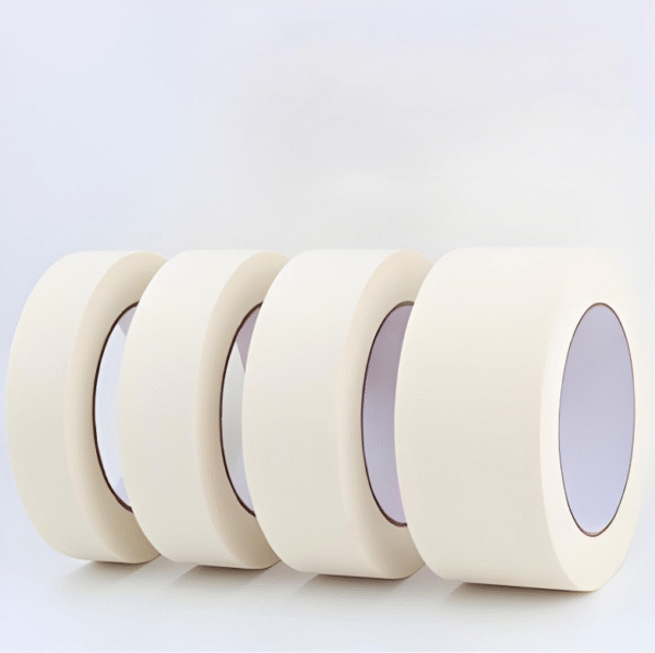 Four rolls of beige masking tape standing upright on a white background