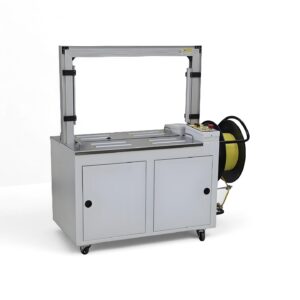 Fully Automatic strapping machine with PP strap reel on the side, used for securing packages in industrial settings.