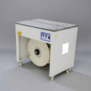 Automatic PP strapping machine bundling cardboard boxes in warehouse