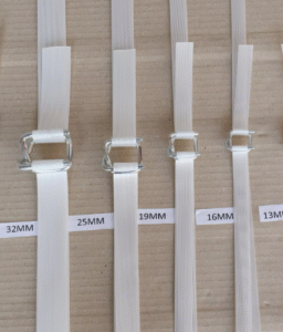 Five sizes of white polyester composite strapping—13mm to 32mm—each threaded through a galvanized wire buckle and displayed on cardboard.
