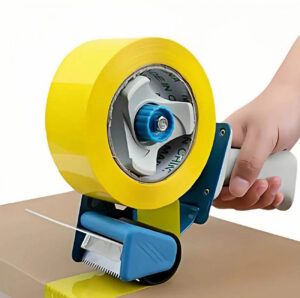 Person loading packing tape into a handheld tape dispenser, showing correct tape direction and threading